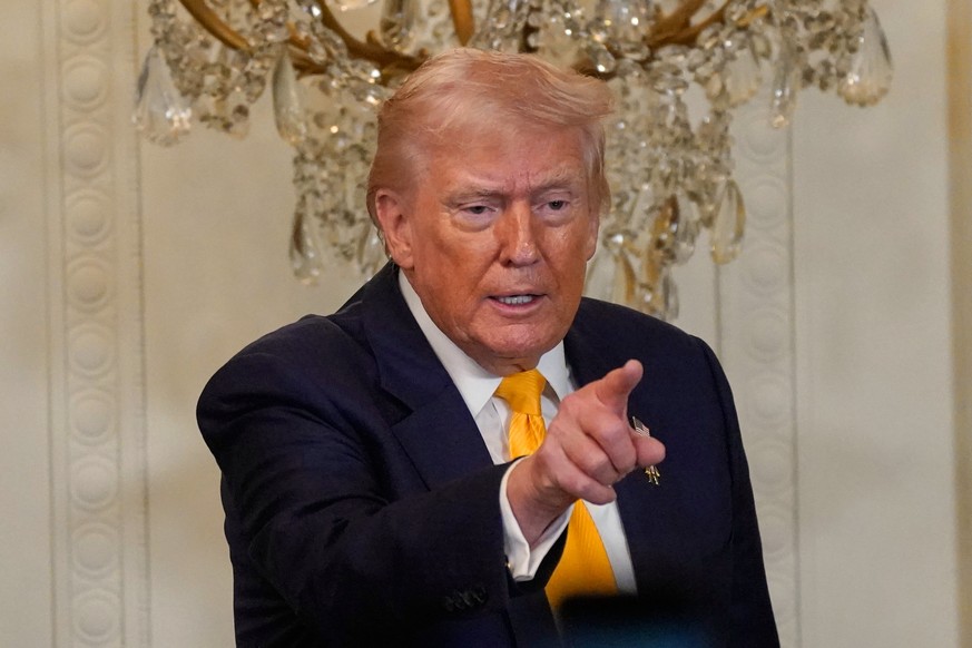 President Donald Trump gestures during a Black History Month event in the East Room of the White House, Wednesday, Feb. 18, 2026, in Washington. (AP Photo/Nathan Howard)
Donald Trump