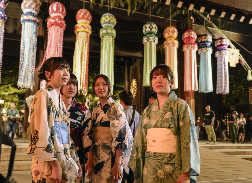 epa10743826 People visit Yasukini Shrine on the eve of the Mitama-matsuri summer festival to comfort the souls of war victims in Tokyo, Japan, 13 July 2023. The Requiem summer festival, held for the f ...