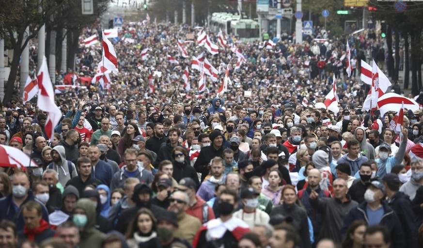 People with old Belarusian national flags march during an opposition rally to protest the official presidential election results in Minsk, Belarus, Sunday, Sept. 27, 2020.Hundreds of thousands of Bela ...