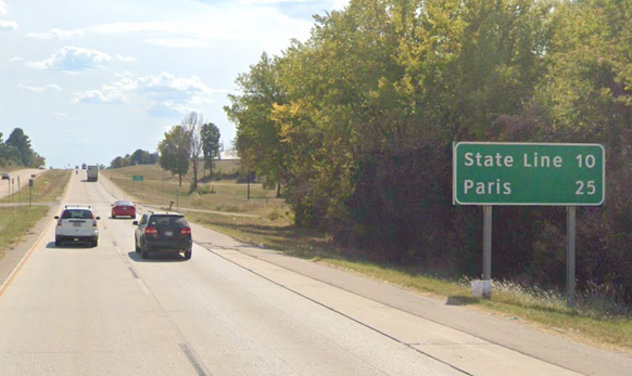 Ein Strassenschild/Wegweiser, welches den Weg nach Paris (Tennessee) anzeigt.