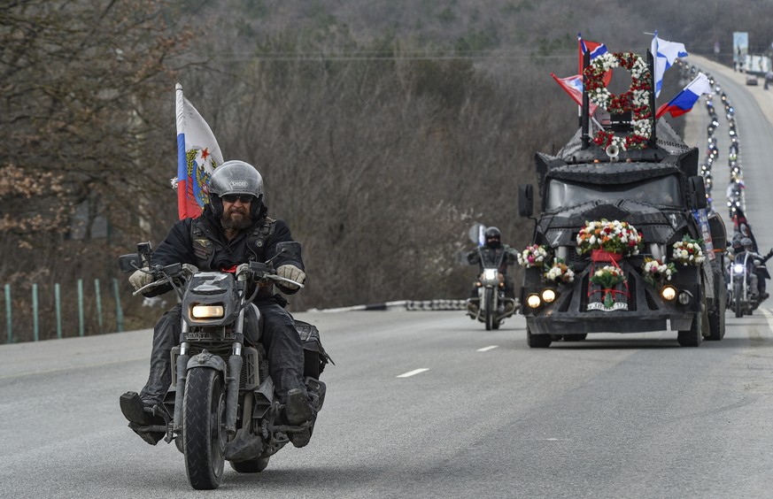 epa10530205 Leader of the Night Wolves motorcycle club Alexander Zaldostanov (L), nicknamed &quot;The Surgeon&quot;, leads a motorcycle parade through Crimea to celebrate the ninth anniversary of Russ ...