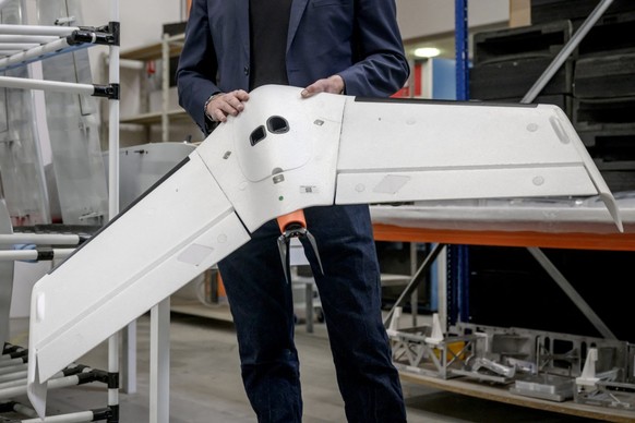 Delair&#039;s co-founder Bastien Mancini holds an &#039;Oskar&#039; drone, capable of carrying warheads for military use, at the company&#039;s factory in Labege, south-western France, on April 11, 20 ...