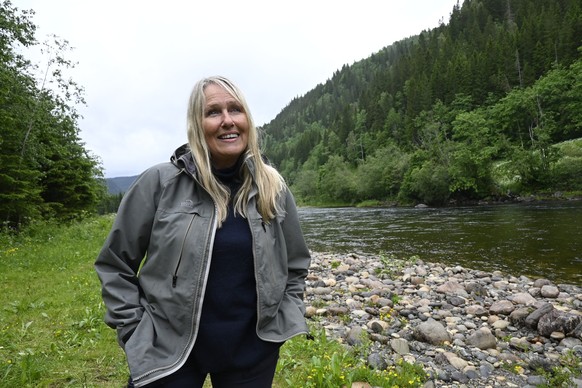 Ann-Britt Bogen owner of Gaula Flyfishing talks to a journalist during an interview in Singsaas, Norway, on June 19, 2025. Waist-deep in a rain-swollen river, Christer Kristoffersen casts his line, la ...