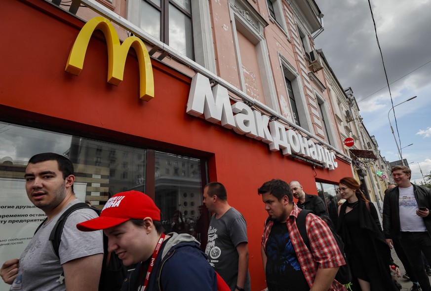 epa09995557 People walk in front of a closed McDonald?s outlet in Moscow, Russia, 04 June 2022. US global fast food franchise on 16 May 2022 in a press release announced that it &quot;will exit the Ru ...