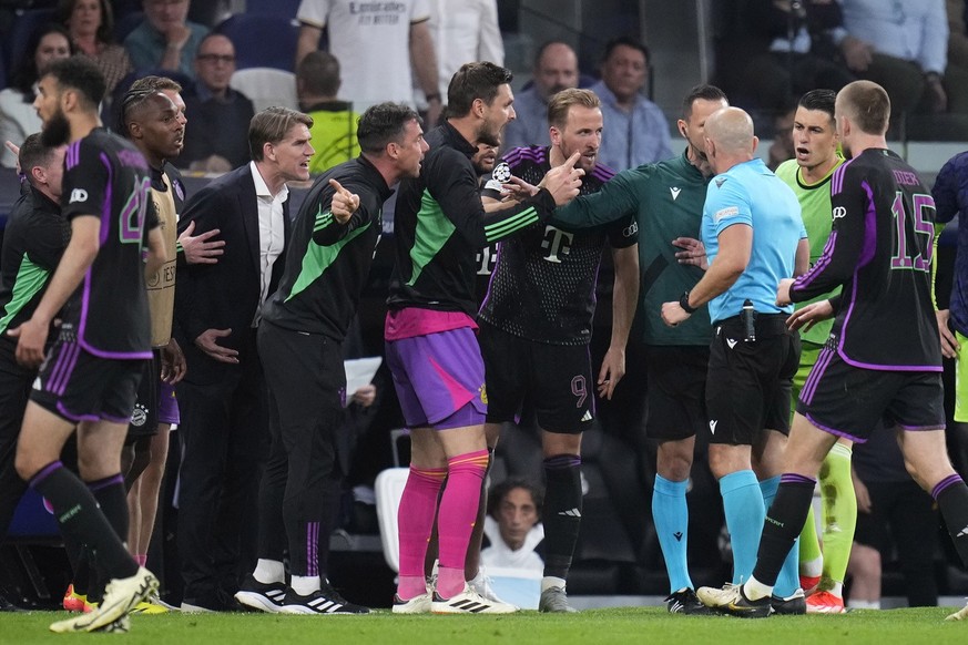 Bayern Munich players argues with referee Szymon Marciniak at the end of the Champions League semifinal second leg soccer match between Real Madrid and Bayern Munich at the Santiago Bernabeu stadium i ...