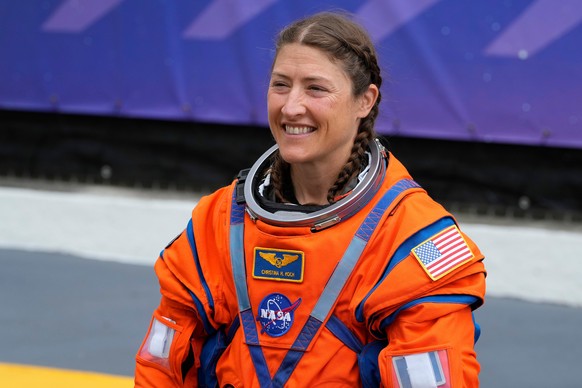 Astronaut Christina Koch smiles as she talks to family members as she leaves the Operations and Checkout Building for a trip to Launch Pad 39-B and a planned liftoff on NASA's Artemis II moon roc ...