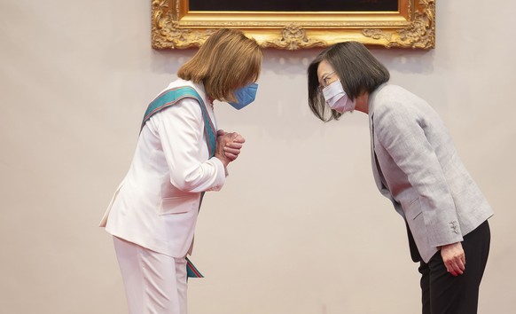 In this photo released by the Taiwan Presidential Office, U.S. House Speaker Nancy Pelosi, left, and Taiwanese President President Tsai Ing-wen gesture during a meeting in Taipei, Taiwan, Wednesday, A ...