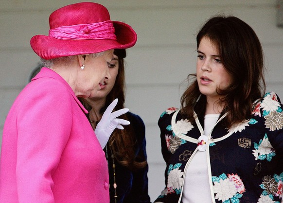 WINDSOR, ENGLAND - JUNE 12: Queen Elizabeth II talks to her granddaughters, Princess Beatrice and Princess Eugenie at the Queen&#039;s Cup Trophy Match at Guards Polo Club in Windsor (Photo by Tim Gra ...
