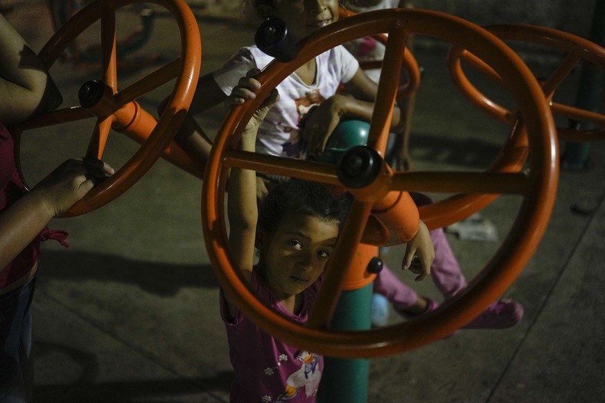 Venezuelan migrant children play in a public park at the La Parada neighborhood, near the border with Venezuela, in Cucuta, Colombia, Friday, Aug. 5, 2022. The border will gradually reopen after the t ...