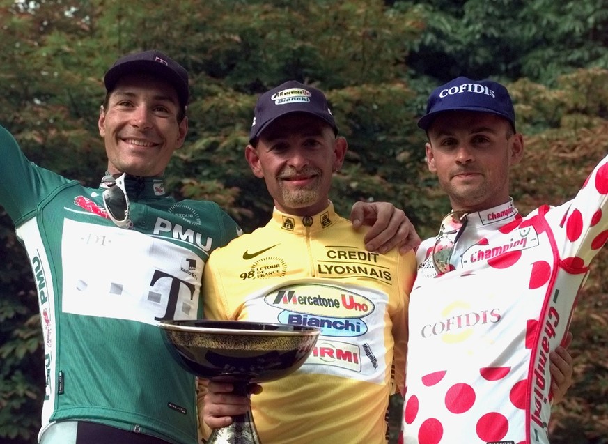 Tour de France winner Marco Pantani of Italy, center, poses on the podium with best sprinter Erik Zabel of Germany, left, and best climber Christophe Rinero of France after the 21st and final stage of ...