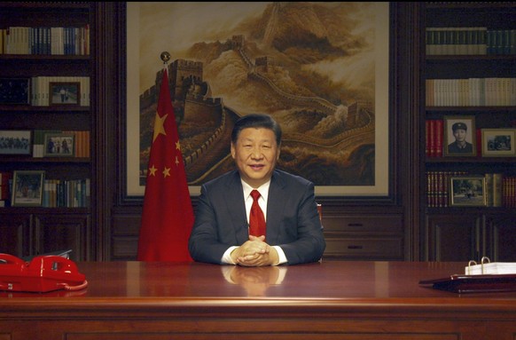 In this photo released by Xinhua News Agency, Chinese President Xi Jinping delivers a New Year speech broadcast on state television in Beijing, China, Sunday Dec. 31, 2017. The official Xinhua News Ag ...
