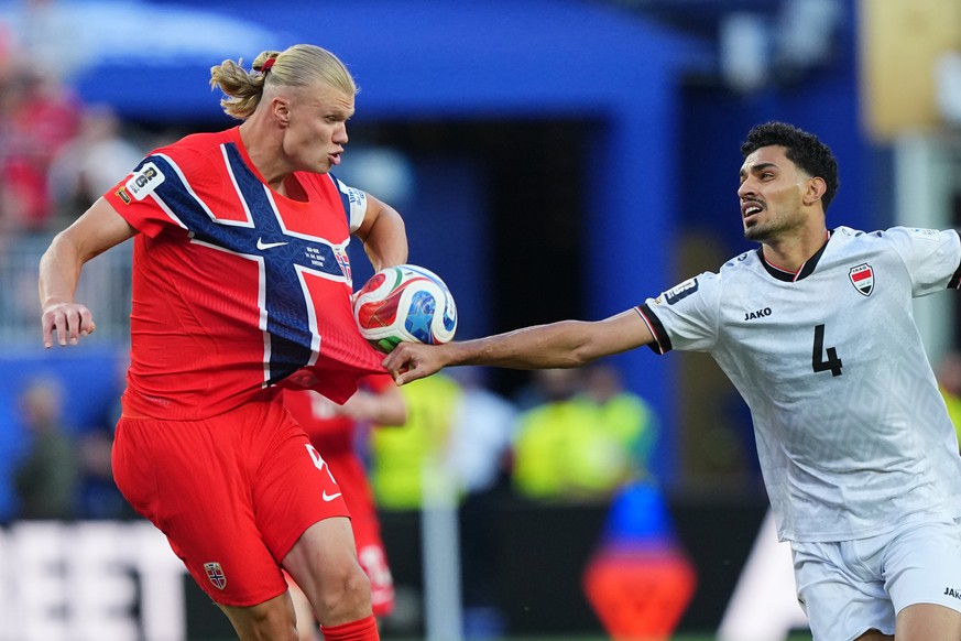 Iraq's Zaid Tahseen, right, grabs Norway's Erling Haaland during the World Cup Group I soccer match between Iraq and Norway in Foxborough, Mass., near Boston, Tuesday, June 16, 2026. (AP Pho ...