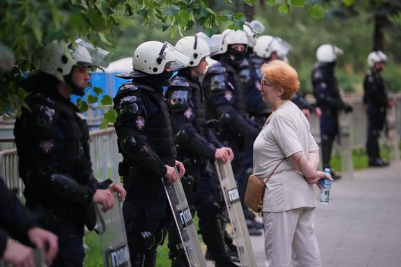 An anti-government protester speaks to riot policemen during a rally led by Serbia's protesting university students who are pushing for major political changes in the Balkan country run by Presid ...