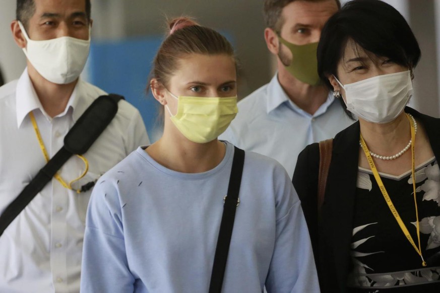 Belarusian Olympic sprinter Krystsina Tsimanouskaya, center, arrives at Narita International Airport in Narita, east of Tokyo Wednesday, Aug. 4, 2021. Tsimanouskaya plans to seek refuge in Europe afte ...