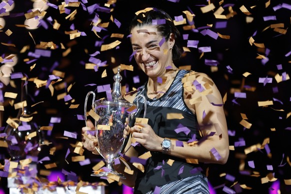 Caroline Garcia, of France, holds the trophy after defeating Aryna Sabalenka, of Belarus, in the singles final at the WTA Finals tennis tournament in Fort Worth, Texas, Monday, Nov. 7, 2022. (AP Photo ...