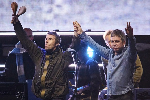 Liam Gallagher, left, and Noel Gallagher of Oasis walk onstage together during their reunion tour in Toronto, Sunday, Aug. 24, 2025. (Sammy Kogan/The Canadian Press via AP)
Noel Gallagher,Liam Gallagh ...