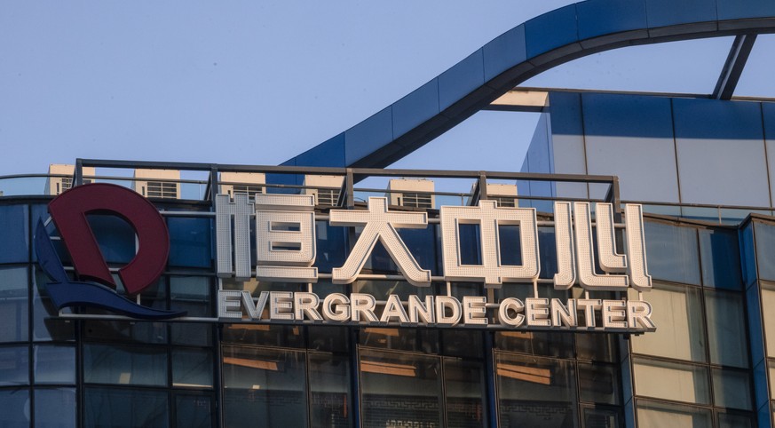 epa09479216 The Evergrande Center logo hangs outside a building in Shanghai, China, 21 September 2021. Evergrande Group is China?s real estate conglomerate and the world?s most indebted property devel ...