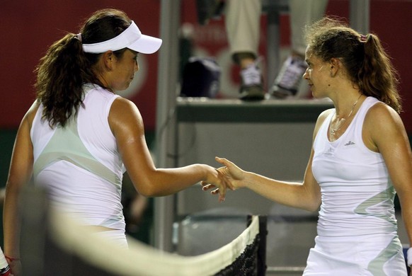 Patty Schnyder of Switzerland (R) shake hands with Shuai Peng of China (L) after their women&#039;s singles match at the Australian Open tennis tournament in Melbourne Park in Melbourne, Australia on  ...