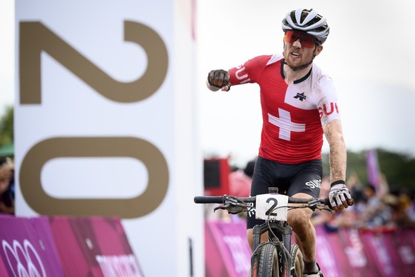Silver medal winner Mathias Flueckiger of Switzerland celebrates as he crossing the finish line during the men&#039;s Cross-country Mountain Bike, MTB, race at the 2020 Tokyo Summer Olympics in Izu ne ...
