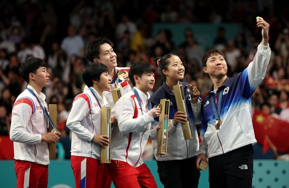 PARIS, FRANCE - JULY 30: Gold medalists, Chuqin Wang and Yingsha Sun of Team People’s Republic of China (C), silver medalists Jong Sik Ri and Kum Yong Kim of Team Democratic People’s Republic of Korea ...