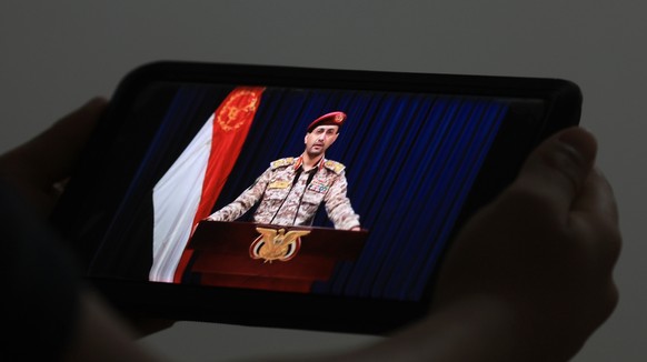 epa11968665 A person watches a mobile phone displaying Houthi military spokesman Yahya Sarea delivering a statement, in Sana&#039;a, Yemen, 16 March 2025. Yemen&#039;s Houthis claimed on 16 March, the ...