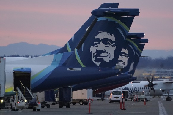 FILE - Alaska Airlines planes are shown parked at gates at sunrise, March 1, 2021, at Seattle-Tacoma International Airport in Seattle. An Alaska Airlines flight made an emergency landing in Oregon on  ...