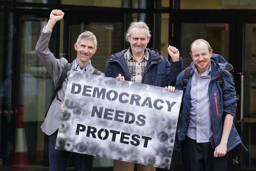 (left-right) Dr Larch Maxey, Extinction Rebellion&#039;s co-founder Roger Hallam and Mike Lynch-White outside Isleworth Crown Court in London, after they received a suspended sentence, for allegedly t ...