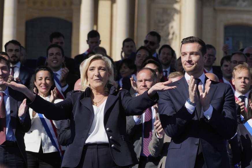 KEYPIX - French far-right leader Marine Le Pen, left, reacts with Jordan Bardella during the French far-right party national rally near the parliament in Paris, Sunday, April 6, 2025. (AP Photo/Michel ...