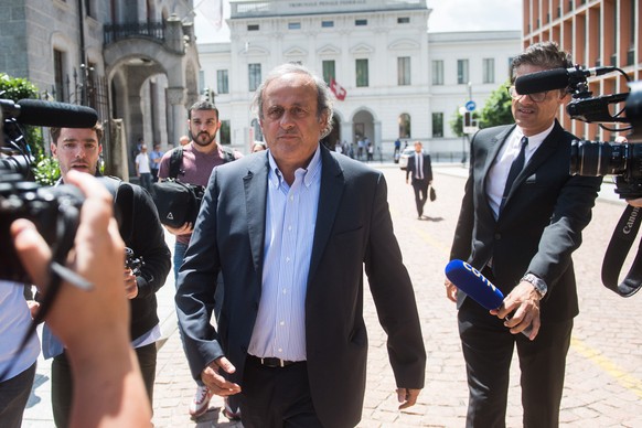 The former president of the the European Football Association (Uefa) Michel Platini, center, is leaving the Swiss Federal Criminal Court in Bellinzona, Switzerland, after the first day of his trial, W ...