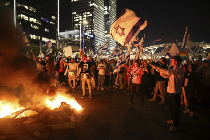 Israelis opposed to Prime Minister Benjamin Netanyahu&#039;s judicial overhaul plan set up bonfires and block a highway during a protest moments after the Israeli leader fired his defense minister, in ...