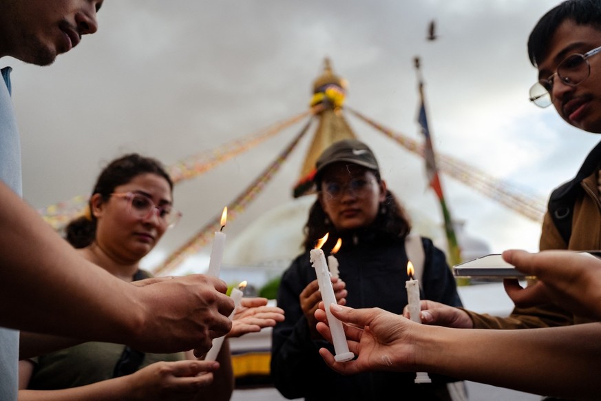 People light candles at Boudhanath Stupa in Kathmandu, Nepal, on September 13, 2025, during a silent tribute to those killed in clashes with police during Nepal&#039;s &#039;Gen Z&#039; protest. (Phot ...