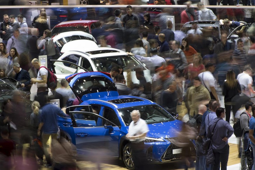 Peoples looking at cars during they visit to the 89th Geneva International Motor Show, in Geneva, Switzerland, Saturday, March 16, 2019. The Motor Show open its gates to the public from 7 to 17 March ...