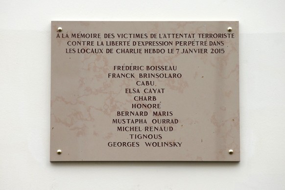 The plaque unveiled earlier by French President Francois Hollande outside satirical newspaper Charlie Hebdo former office, is pictured Tuesday, Jan. 5, 2016 in Paris. Hollande is honoring 17 victims k ...