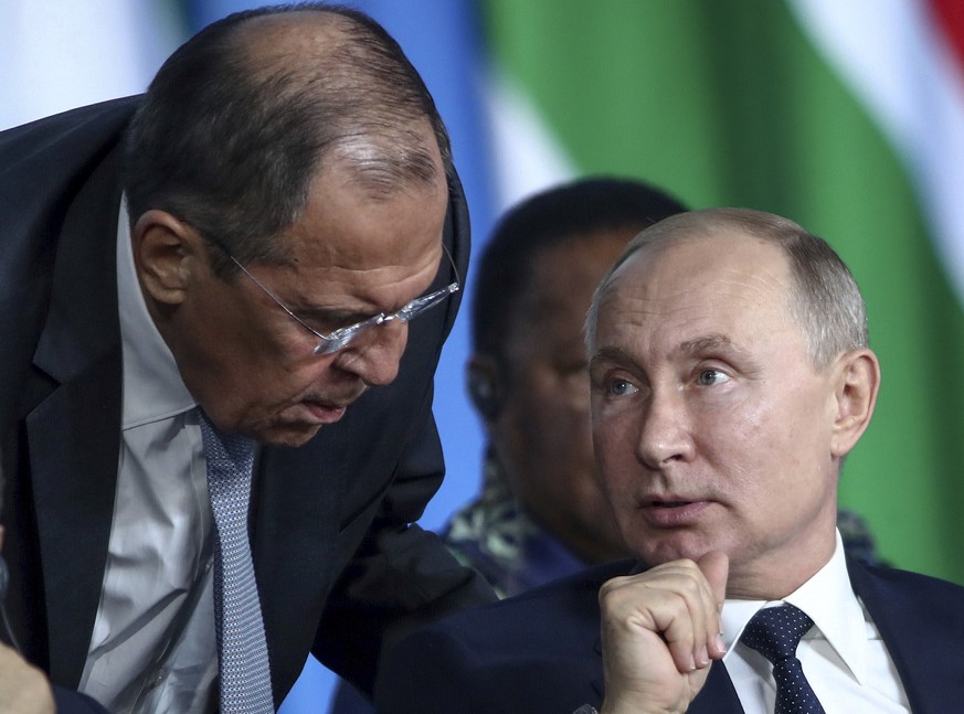 FILE - Russian President Vladimir Putin, right, listens to Russian Foreign Minister Sergey Lavrov, top, as Egyptian President Abdel Fattah el-Sisi sits next during a plenary session at the Russia-Afri ...