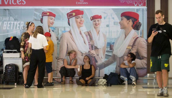 Stranded travelers wait as flights to the Middle East are cancelled following the attack on Iran by the U.S. and Israel, at Ngurah Rai International Airport in Kuta, Bali, Indonesia on Sunday, March 1 ...