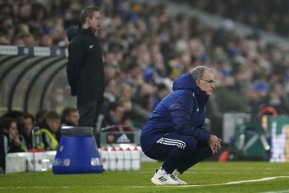 Leeds United&#039;s head coach Marcelo Bielsa squats on the touchline during the English Premier League soccer match between Leeds United and Arsenal at Elland Road in Leeds, England, Saturday, Dec. 1 ...