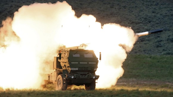 FILE - In this May 23, 2011, file photo a launch truck fires the High Mobility Artillery Rocket System (HIMARS) produced by Lockheed Martin during combat training in the high desert of the Yakima Trai ...