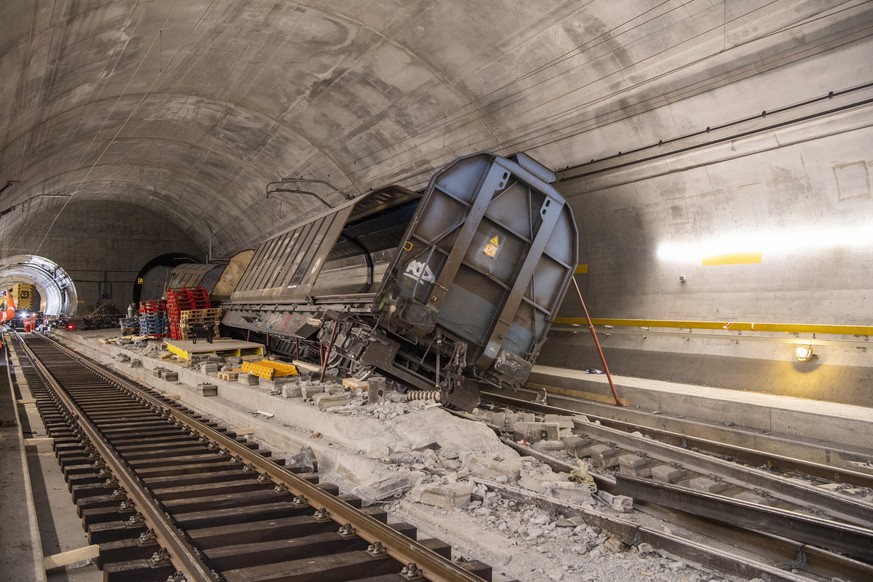 FILE - Accident-damaged freight wagons stand at the scene of the accident in the Gotthard base tunnel near Faido during a media tour at the accident site on Wednesday, September 6, 2023 in Faido in th ...