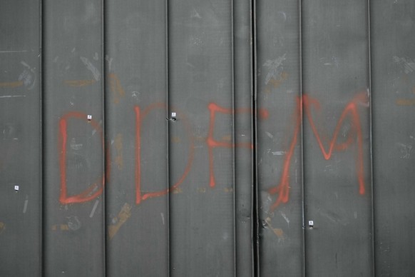 (FILES) This photograph taken on April 15, 2025 shows bullet impacts and the letters &quot;DDFM&quot; spray-painted on a door of the Toulon-La Farlede prison ahead of a visit of the French Minister of ...