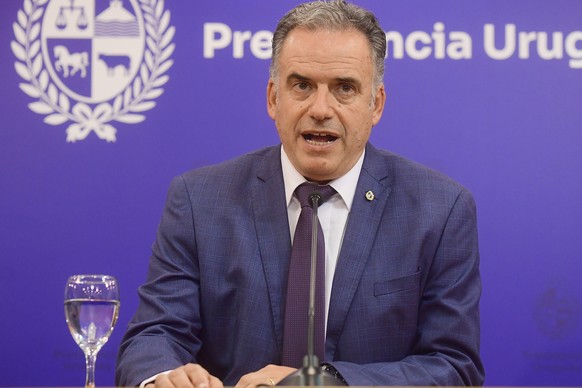 epa12736101 Uruguayan President Yamandu Orsi speaks during a press conference in Montevideo, Uruguay, 13 February 2026. The Uruguayan government has decided to terminate the 2023 contract with the Spa ...