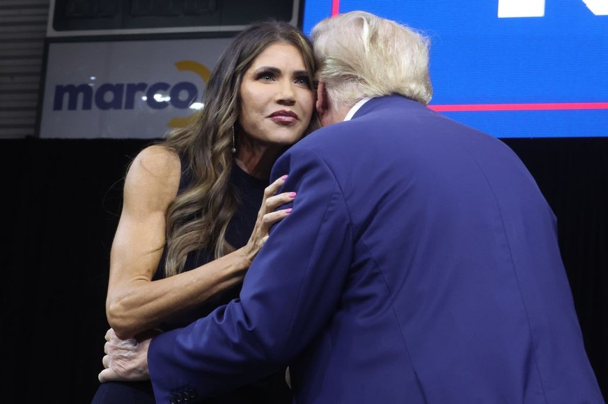 RAPID CITY, SOUTH DAKOTA - SEPTEMBER 08: Republican presidential candidate former President Donald Trump greets South Dakota Governor Kristi Noem after she introduced him at the Monument Leaders Rally ...