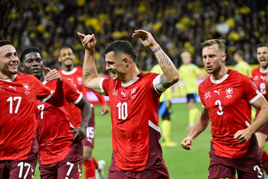 epa12445796 Switzerland&#039;s Granit Xhaka (C) celebrates scoring the 0-1 goal during the 2026 FIFA World Cup qualifying soccer match between Sweden and Switzerland in Stockholm, Sweden, 10 October 2 ...