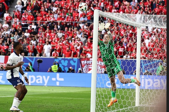 epa11463280 Goalkeeper Jordan Pickford of England (R) in action against a corner kick by Xherdan Shaqiri of Switzerland (unseen) during the UEFA EURO 2024 quarter-finals soccer match between England a ...