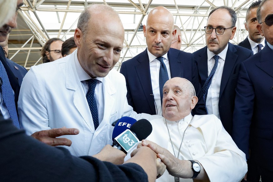 epa10694382 Pope Francis (R) speaks to members of the media while flanked by Doctor Sergio Alfieri (L), the surgeon who operated on him, as he leaves the Gemelli Polyclinic Hospital in Rome, Italy, 16 ...