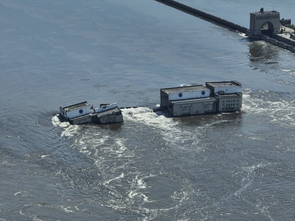 CAPTION CORRECTS LOCATION - Water flows over the collapsed Kakhovka dam in Nova Kakhovka, in Russian-occupied Ukraine, Wednesday, June 7, 2023. (AP Photo)