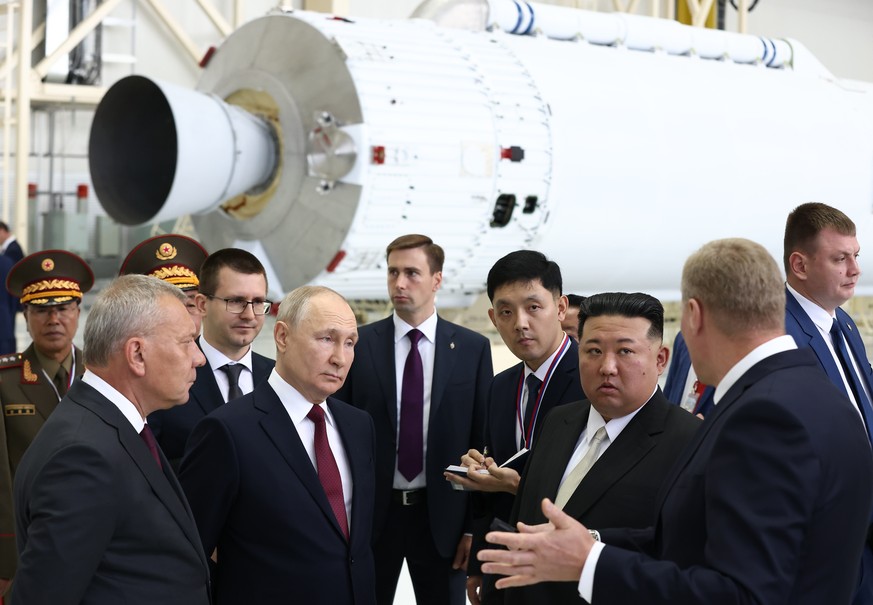 epa10857899 Russian President Vladimir Putin (2nd-L) and North Korean leader Kim Jong Un (3d-R), accompanied by head of Russian state space corporation Roscosmos Yuri Borisov (L), visit the Vostochny  ...