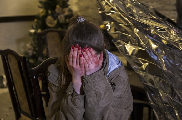 epa11068652 An injured woman reacts after an overnight Russian rocket attack in Kharkiv, Ukraine, 10 January 2024. At least 10 people, including one foreign journalist, were injured as a result of two ...