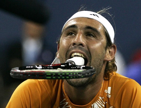 Marcos Baghdatis, of Cyprus, holds his racquet in his mouth during his match against Andre Agassi, of the United States, at the US Open tennis tournament in New York, Thursday, Aug. 31, 2006. (AP Phot ...