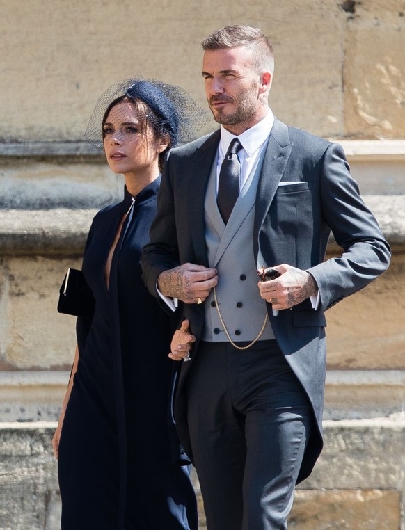 WINDSOR, ENGLAND - MAY 19: David Beckham and Victoria Beckham attend the wedding of Prince Harry to Ms Meghan Markle at St George&#039;s Chapel, Windsor Castle on May 19, 2018 in Windsor, England. Pri ...
