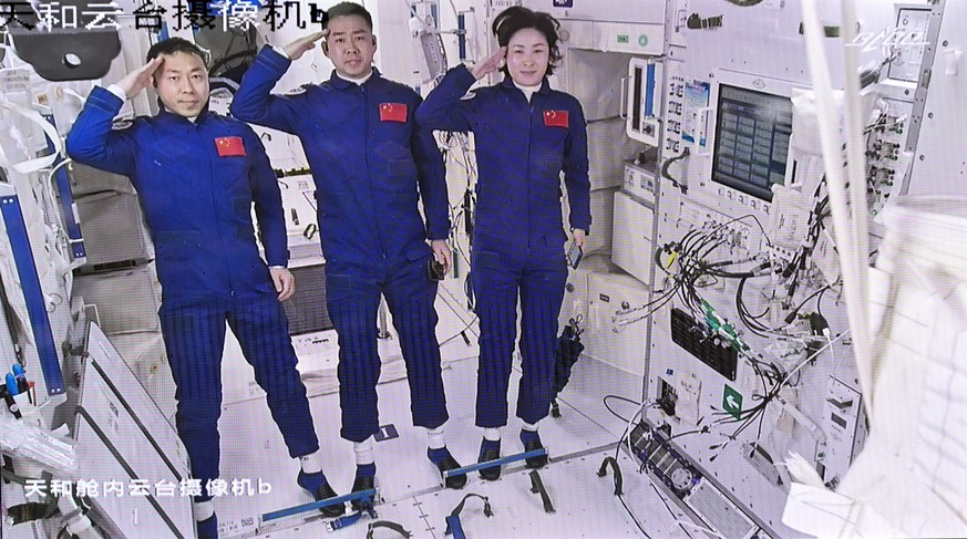 In this screen image captured at Beijing Aerospace Control Center released by Xinhua News Agency, Chinese astronauts from left, Liu Yang, Chen Dong and Cai Xuzhe salute after entering the space statio ...